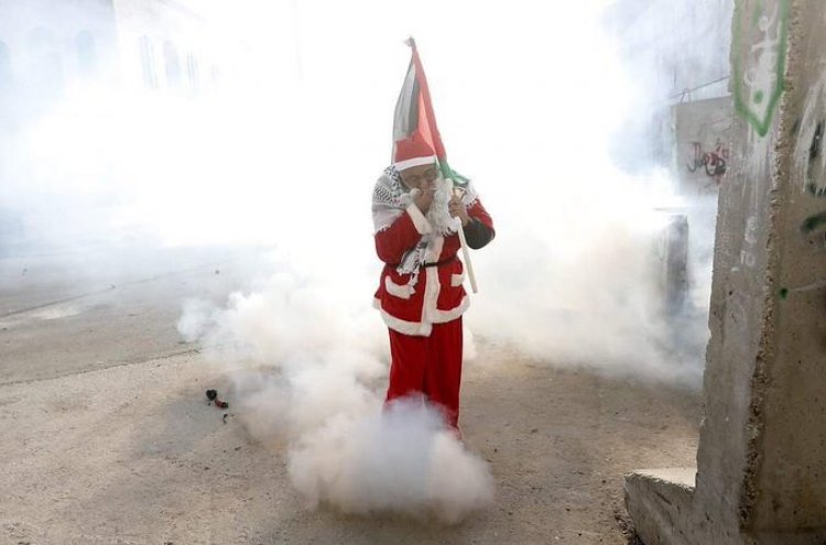 Santa being Teargassed by Israeli forces in Palestine