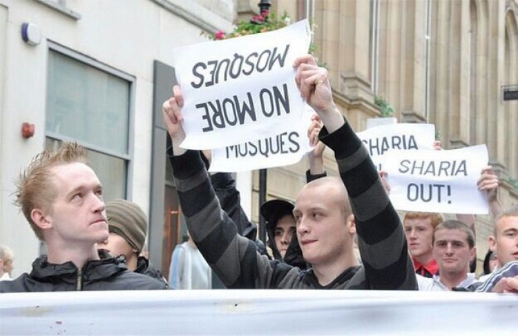 Protestor holding up anti muslim sign